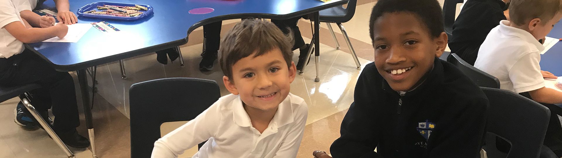 Two young students smiling